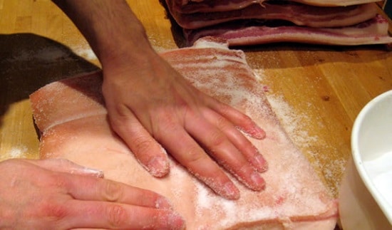 Dry curing with a salt-based rub.